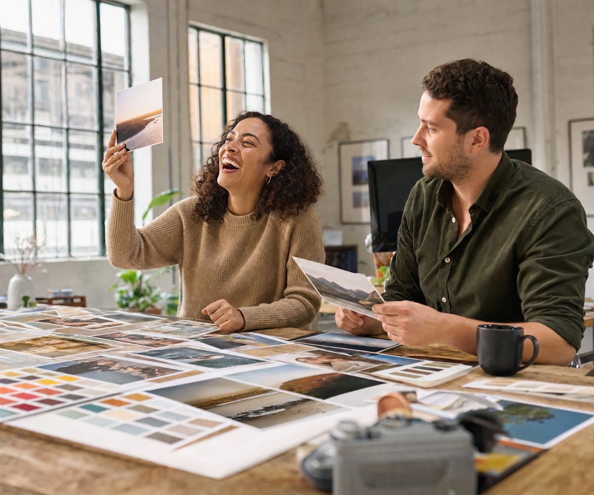 Two marketers choosing between printed photo proofs and color swatches